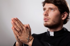 Priest with rosary